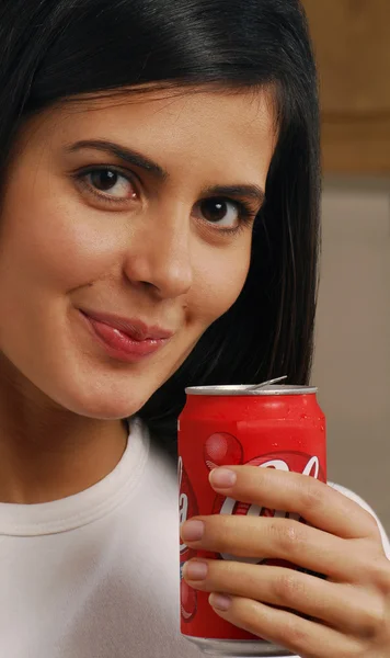 Cute brunette drinking out of a can — Stock Photo, Image