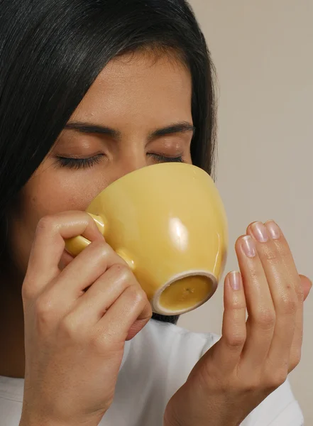 Hermosa joven latina bebiendo una taza caliente de bebida — Foto de Stock