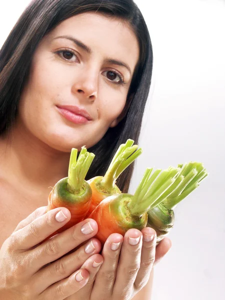 Young woman holding fresh carrots on white background — Stock Photo, Image