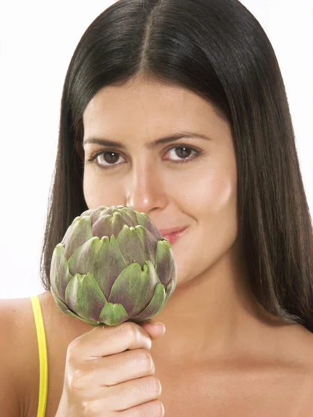 Young woman holding fresh artichoke — Stock Photo, Image