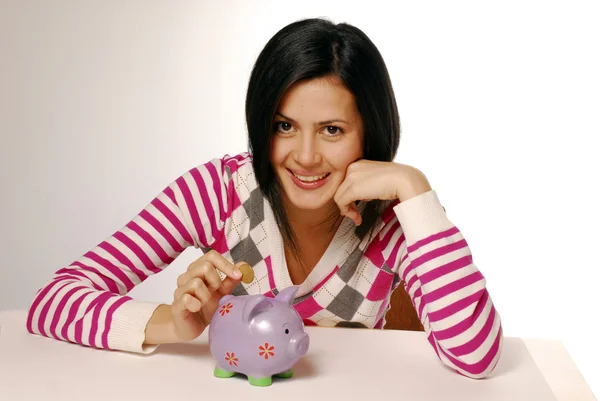 Young woman and piggy bank saving money — Stock Photo, Image