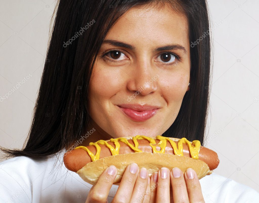 Young woman portrait eating a hotdog