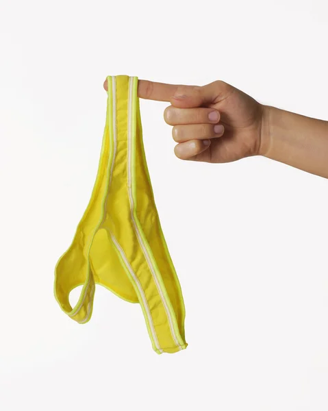 Female hand holding her panties — Stock Photo, Image