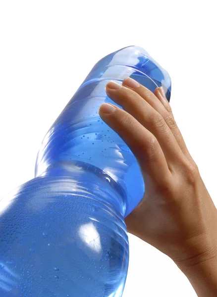 Mano femminile in possesso di una bottiglia di acqua minerale di plastica . — Foto Stock