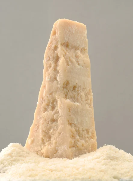 Пармезанський сир стоїть на тертому сирі — стокове фото