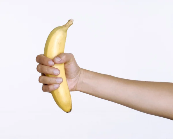 Mão segurando uma banana — Fotografia de Stock