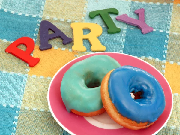 Colored dough nuts on a party table. — Stock Photo, Image