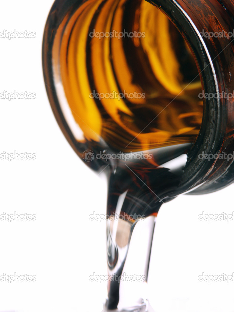 Pouring medicine syrup detail on white background