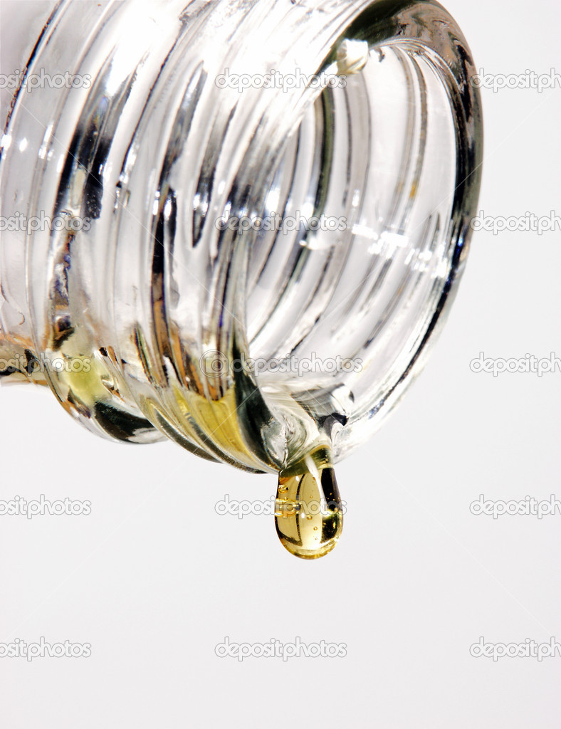 Pouring beer from a bottle on white background