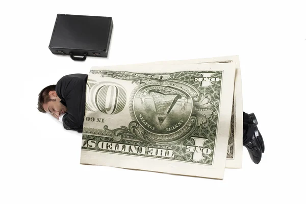 Young happy businessman has a rest under a big dollar bill. — Stock Photo, Image