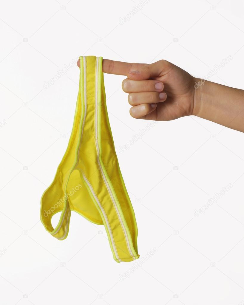 Female hand holding her panties Stock Photo by