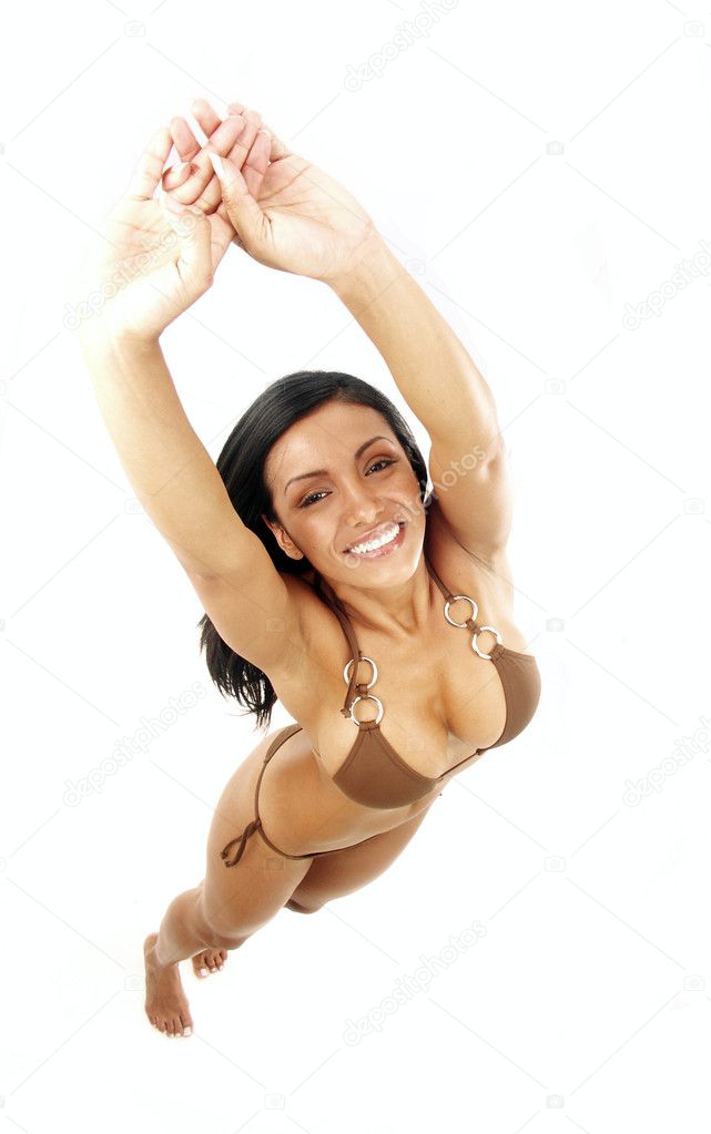 Stretching attractive hispanic woman in swimsuit on white background.
