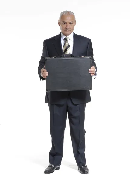 Senior businessman holding a suitcase. — Stock Photo, Image