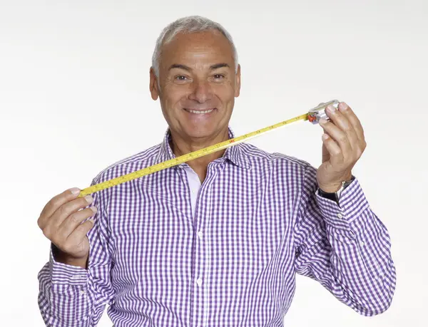 Senior architect man holding a measure tape. — Stock Photo, Image