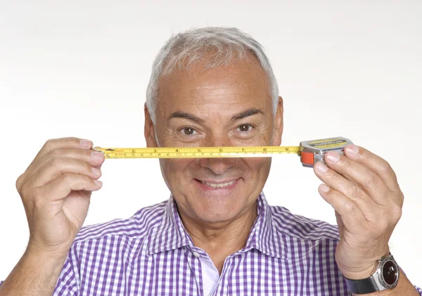 Senior architect man holding a measure tape. — Stock Photo, Image