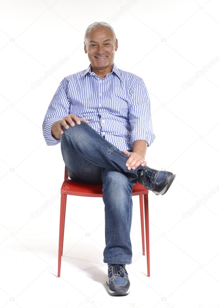 Portrait of a casual senior sitting on a chair on white background.