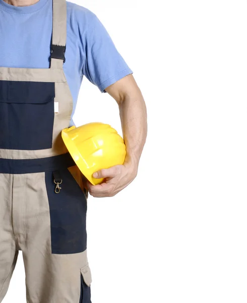 Ouvrier de la construction tenant un casque jaune . — Photo