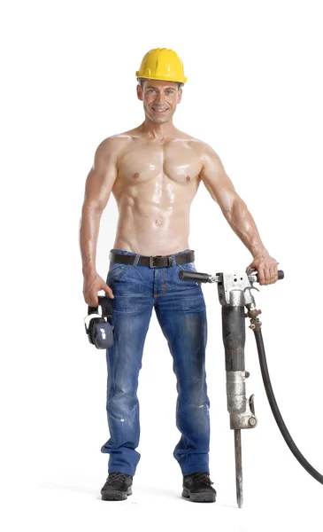 Healthy worker holding a pneumatic drill on white background. — Stock Photo, Image