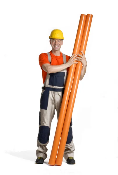 Plumber holding two plastic orange tubes. — Stock Photo, Image