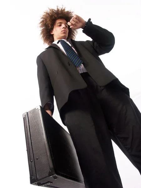 Joven hombre de negocios mirando su reloj y sosteniendo una maleta . — Foto de Stock