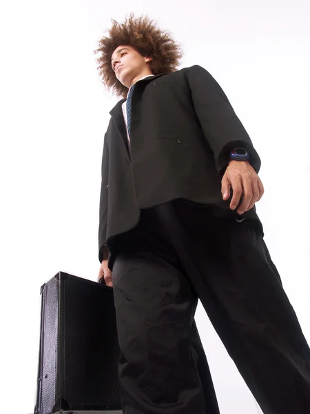 Young businessman afro style holding a suitcase. — Stock Photo, Image
