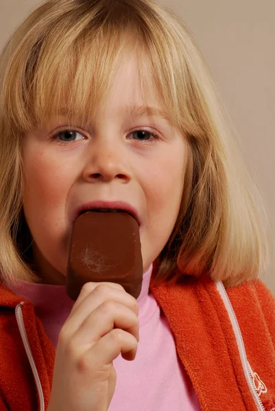 Little girl eating a chocolate ice cream. — Stock Photo, Image