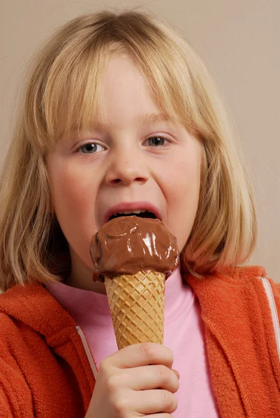 Little girl eating a chocolate ice cream. — Stock Photo, Image
