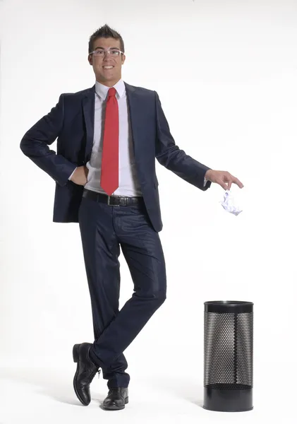Young businessman dropping a paper in a waste basket. — Stock Photo, Image