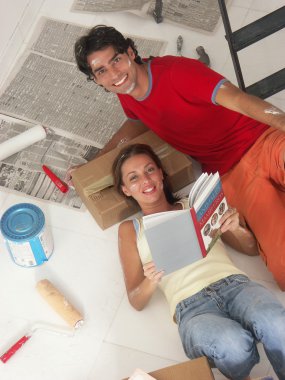 Hispanic young couple moving to a new home. clipart