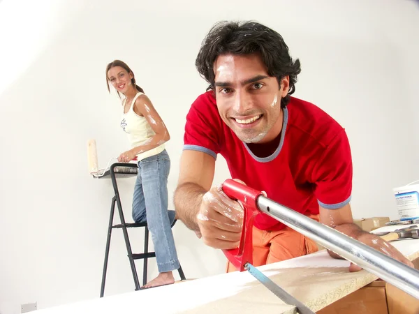 Hispanic couple working at new home. — Stock Photo, Image