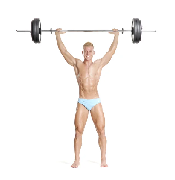 Young and strong man holding a barbell. — Stock Photo, Image