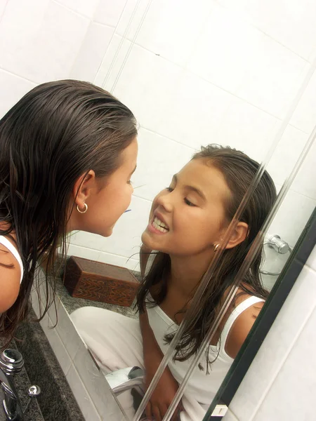 Little girl watching herself at mirror. Little girl watching her teeth. — Stock Photo, Image