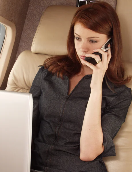 Businesswoman working on a private plane — Stock Photo, Image