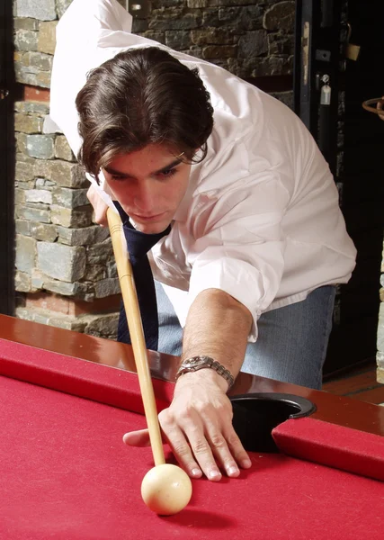 Young man plays billiards — Stock Photo, Image