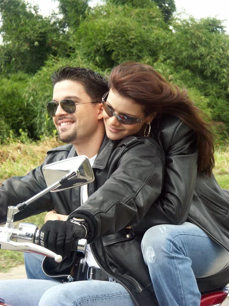 Couple enjoying a ride by motorcycle — Stock Photo, Image