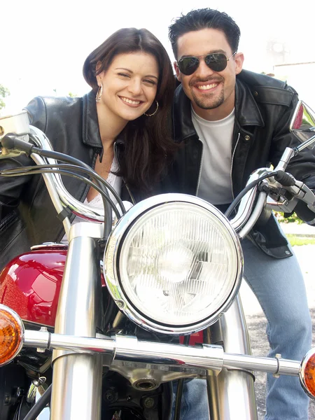 Couple enjoying a ride by motorcycle — Stock Photo, Image