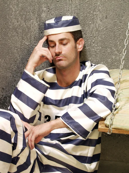 Depressed prisoner in a prison cell. Boring prisoner. — Stock Photo, Image