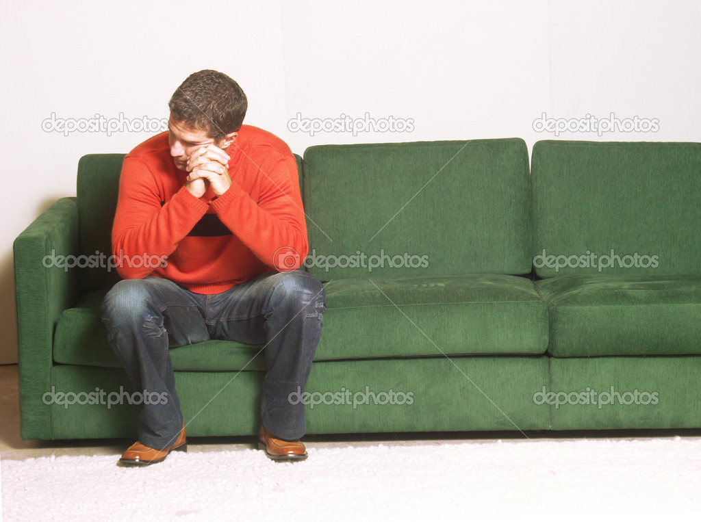 A man sitting on a sofa.