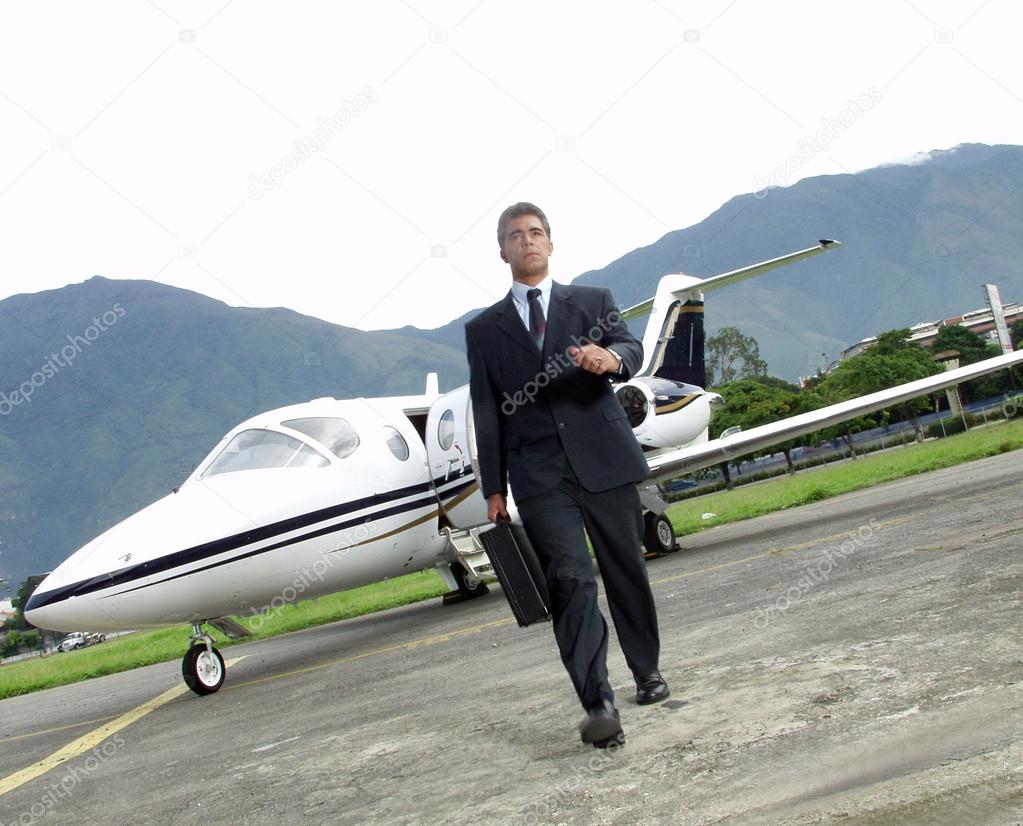 Businessman outside his private plane.