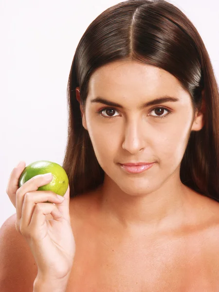 Junge Frau hält und isst frische Zitrone. — Stockfoto