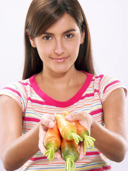 Young woman holding fresh carrots — Stock Photo, Image