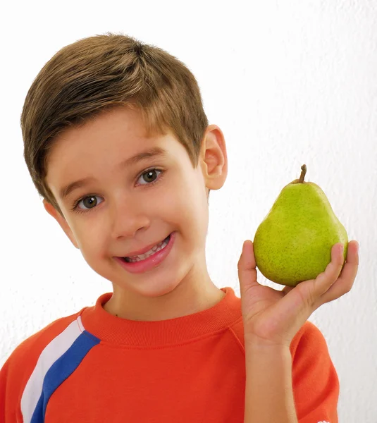 Little kid holding fresh pear — Stock Photo, Image