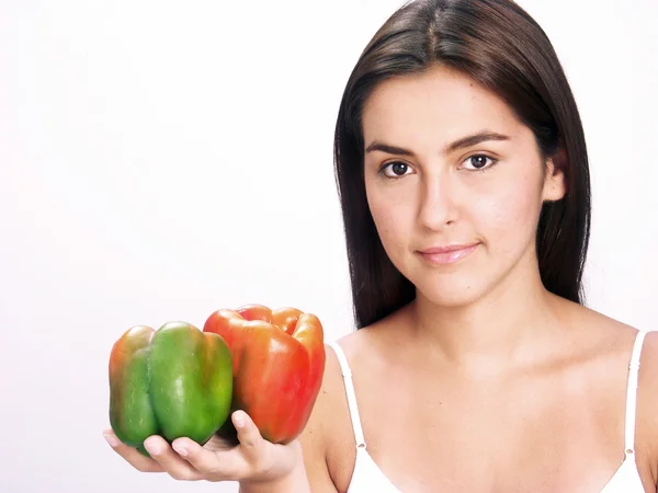 Young woman holding peppers — Stock Photo, Image