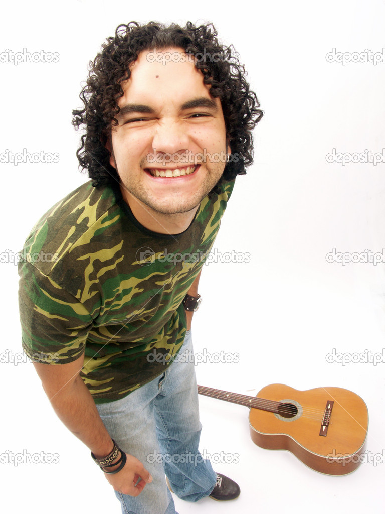 Young man posing with his guitar.
