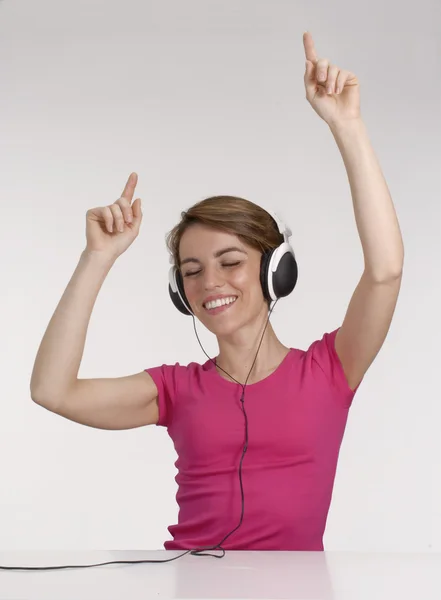 Mujer joven escuchando música usando auriculares . — Foto de Stock