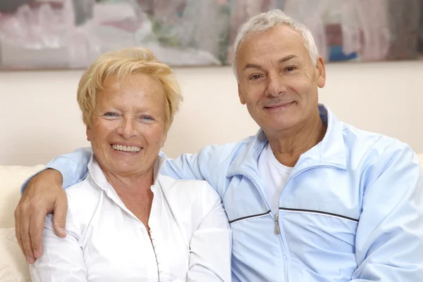 Casal sênior compartilhando e sorrindo em casa . — Fotografia de Stock