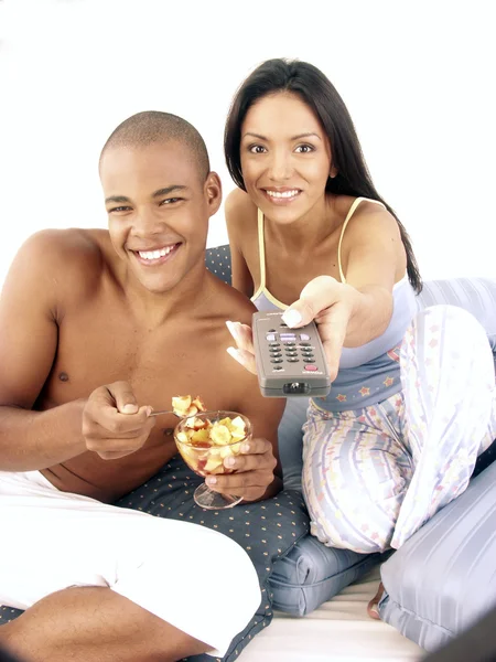 Young hispanic couple enjoying and eating fruit salad on bed. — Stock Photo, Image