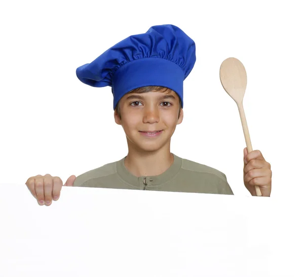 Little kid chef holding a white panel and wood spoon. — Stock Photo, Image