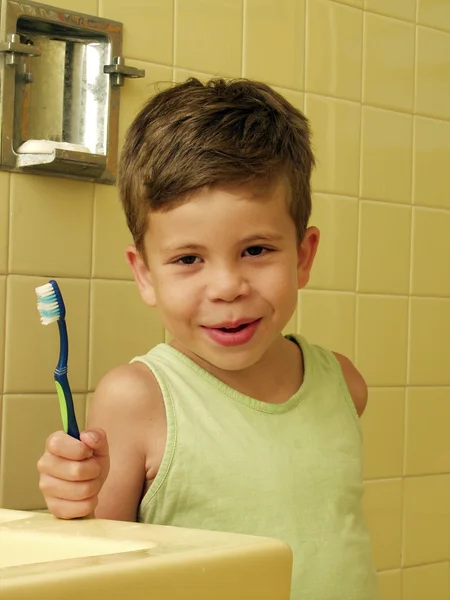 Kid escovando dentes em um banheiro . — Fotografia de Stock