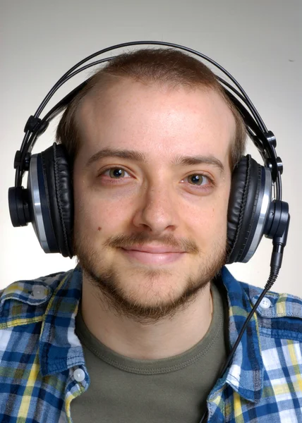 Young man using headphones,Dj listening music. — Stock Photo, Image